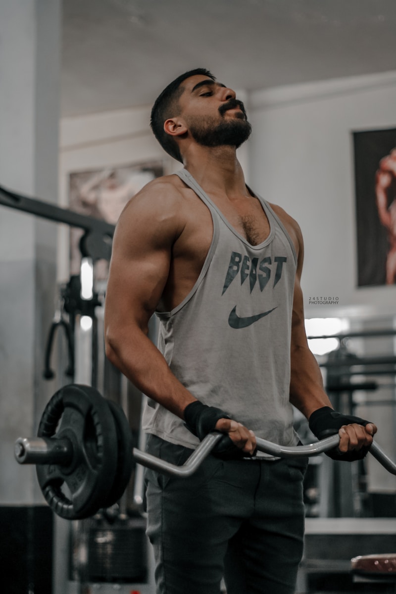 a man holding a barbell in a gym